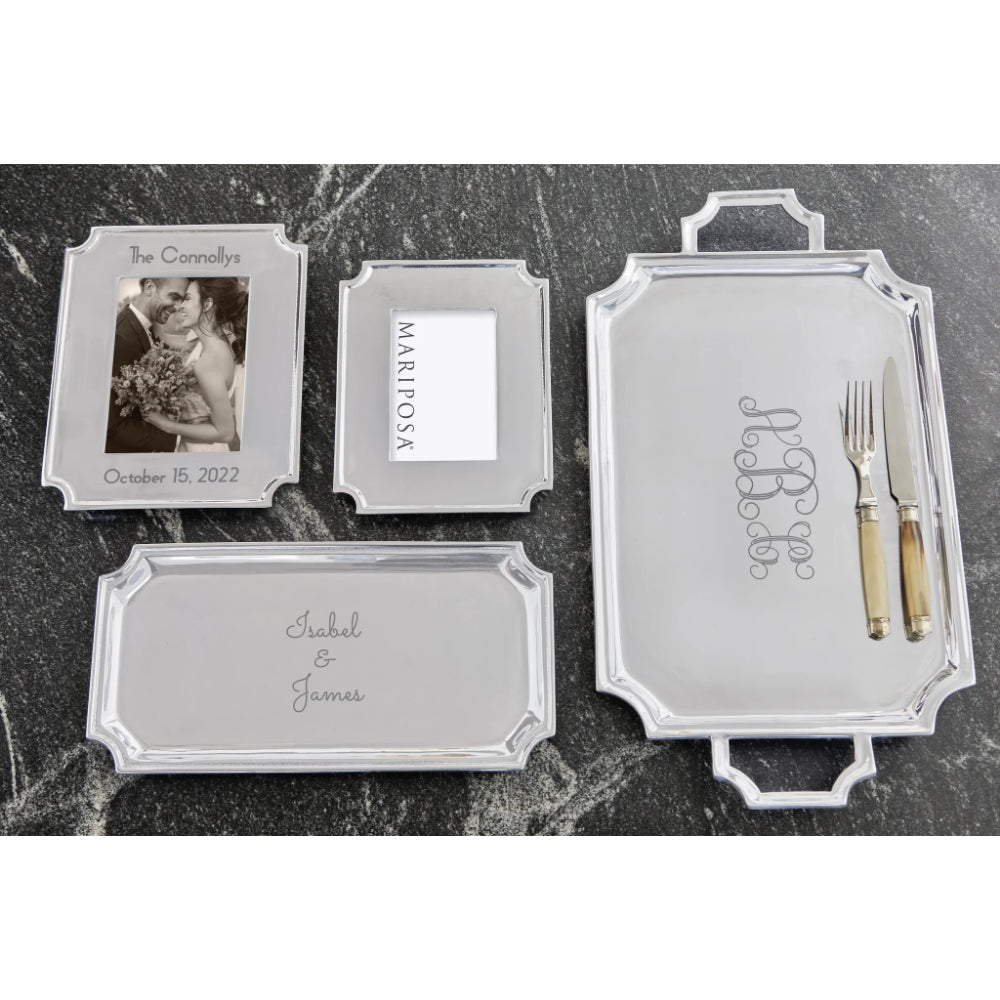 A display of Mariposa engraved frames and platters on a grey/black background.