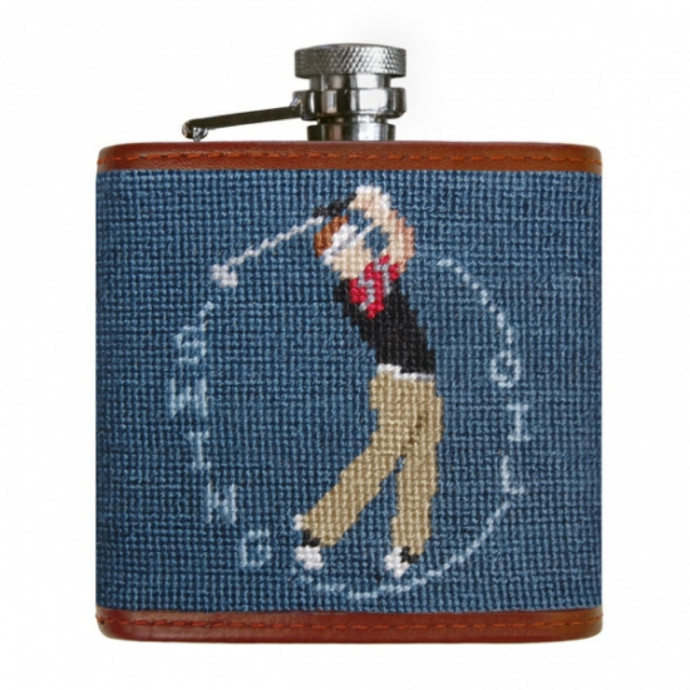 A flask with a golfer swinging on blue colors on a white background.
