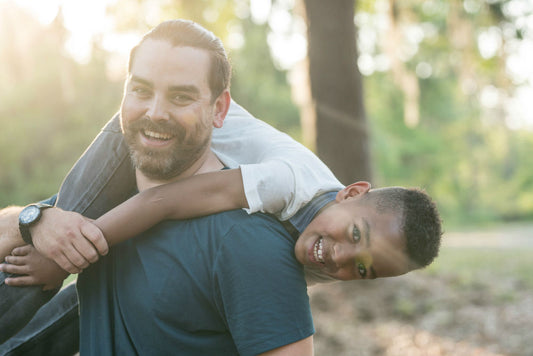 father with son on shoulder