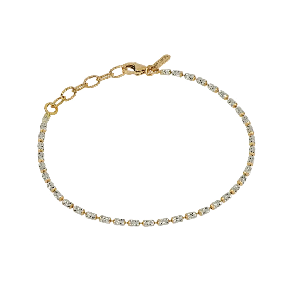 Gold bracelet with clear stones on a white background