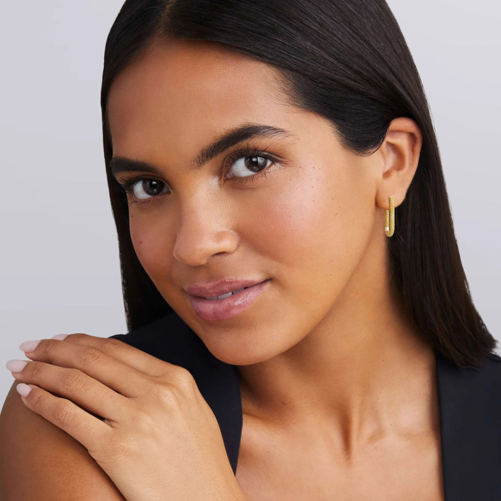 Woman wearing two tone earrings 