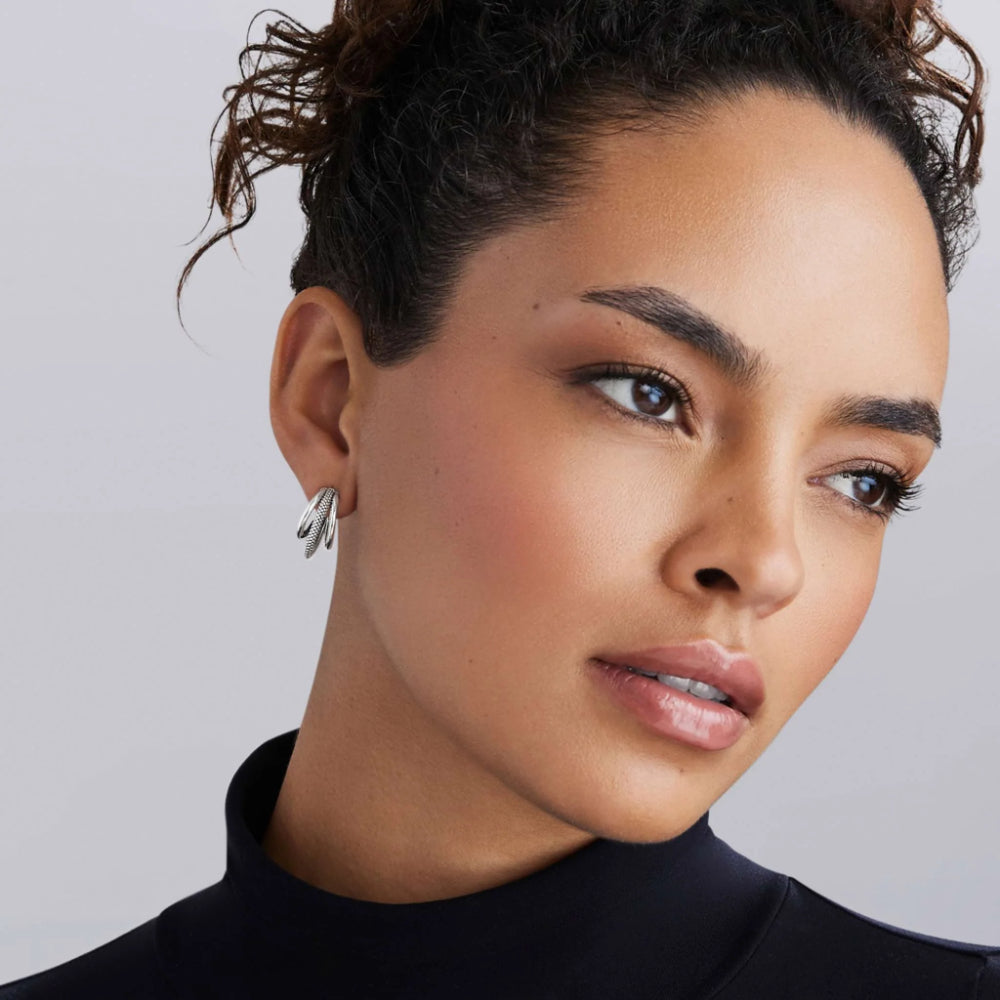Woman wearing 3 hooped earring 