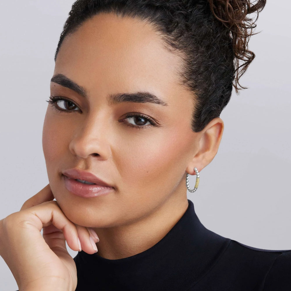 Woman wearing two tone hoop earrings 