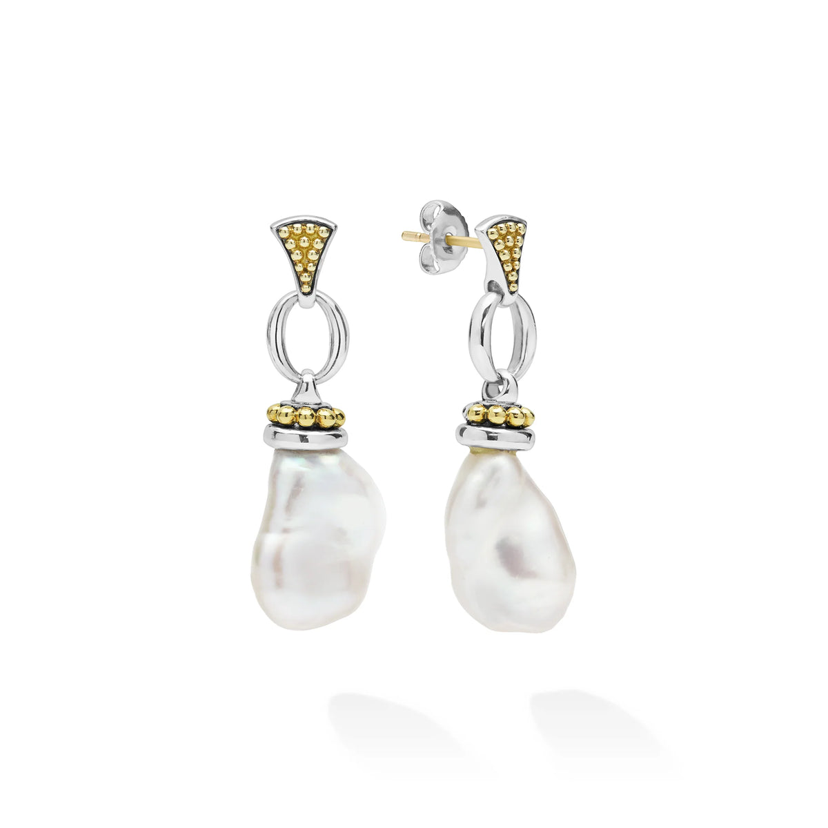 A pair of silver and yellow gold drop earrings with baroque pearl dangles, shown on a clean white background.