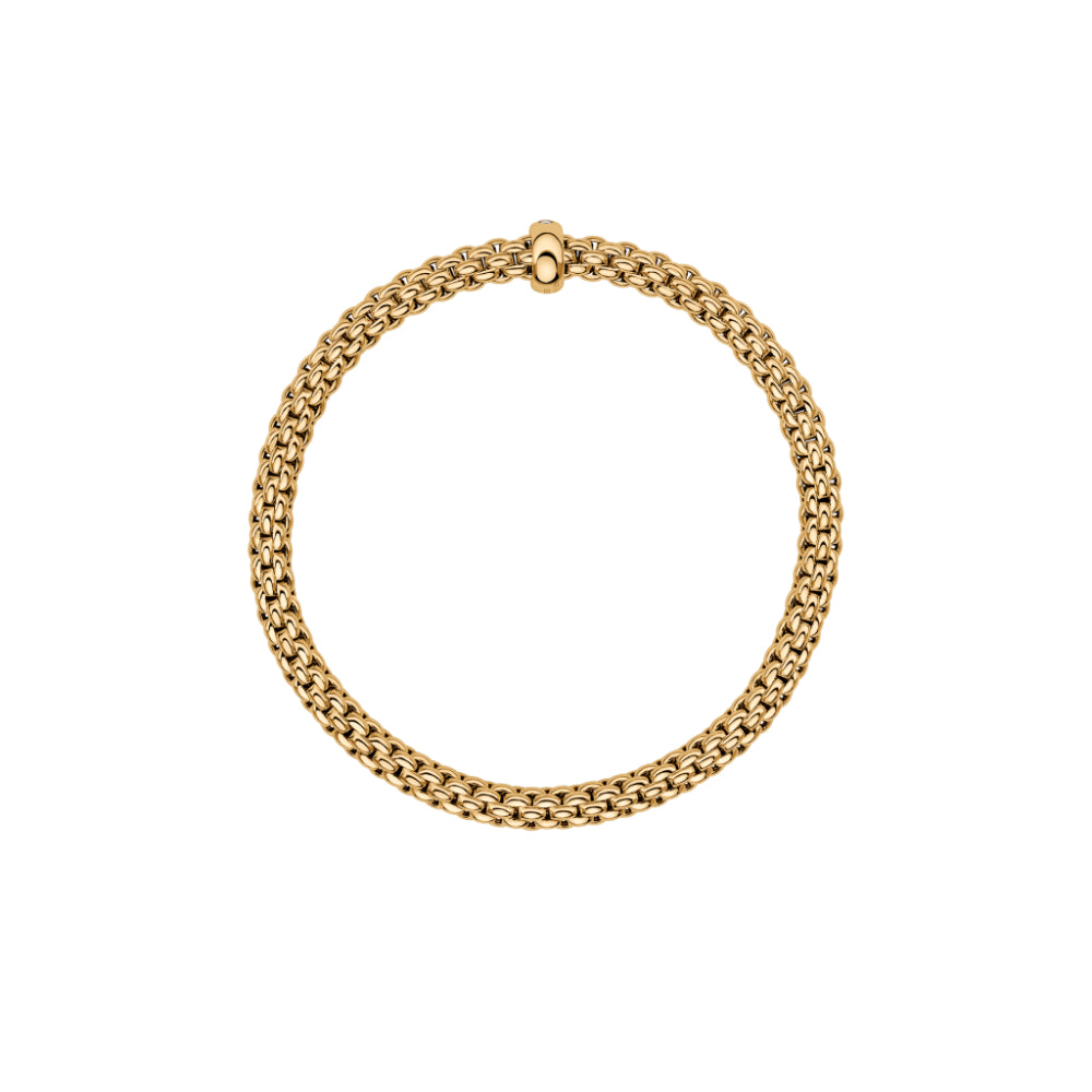A flexible 18 carat gold bracelet with a single diamond