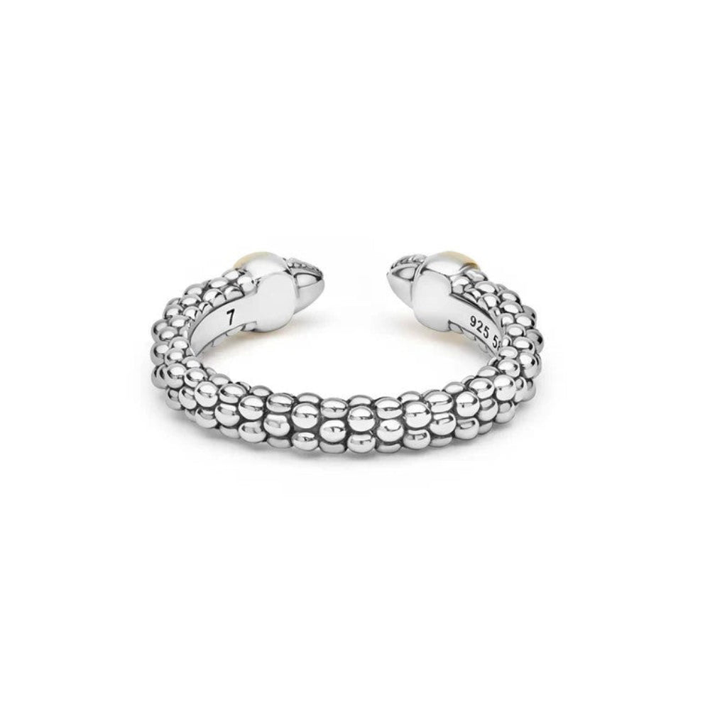 Sterling silver open cuff ring with a textured beaded exterior, two gold-toned heart-shaped end caps, and pavé-set clear stones on one side. 