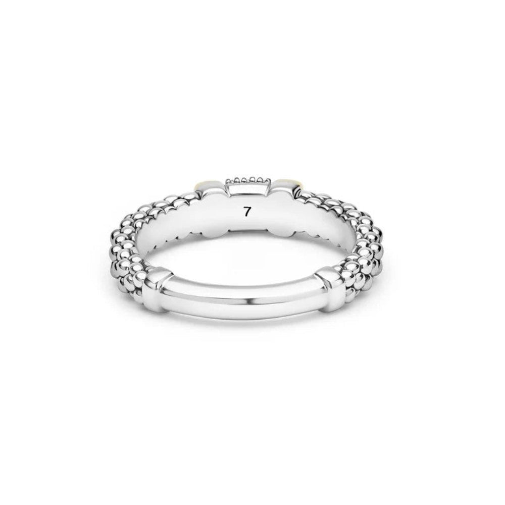 Sterling  silver ring with a textured beaded band, a central pavé diamond section, and two yellow gold cylindrical accents. shaft of ring