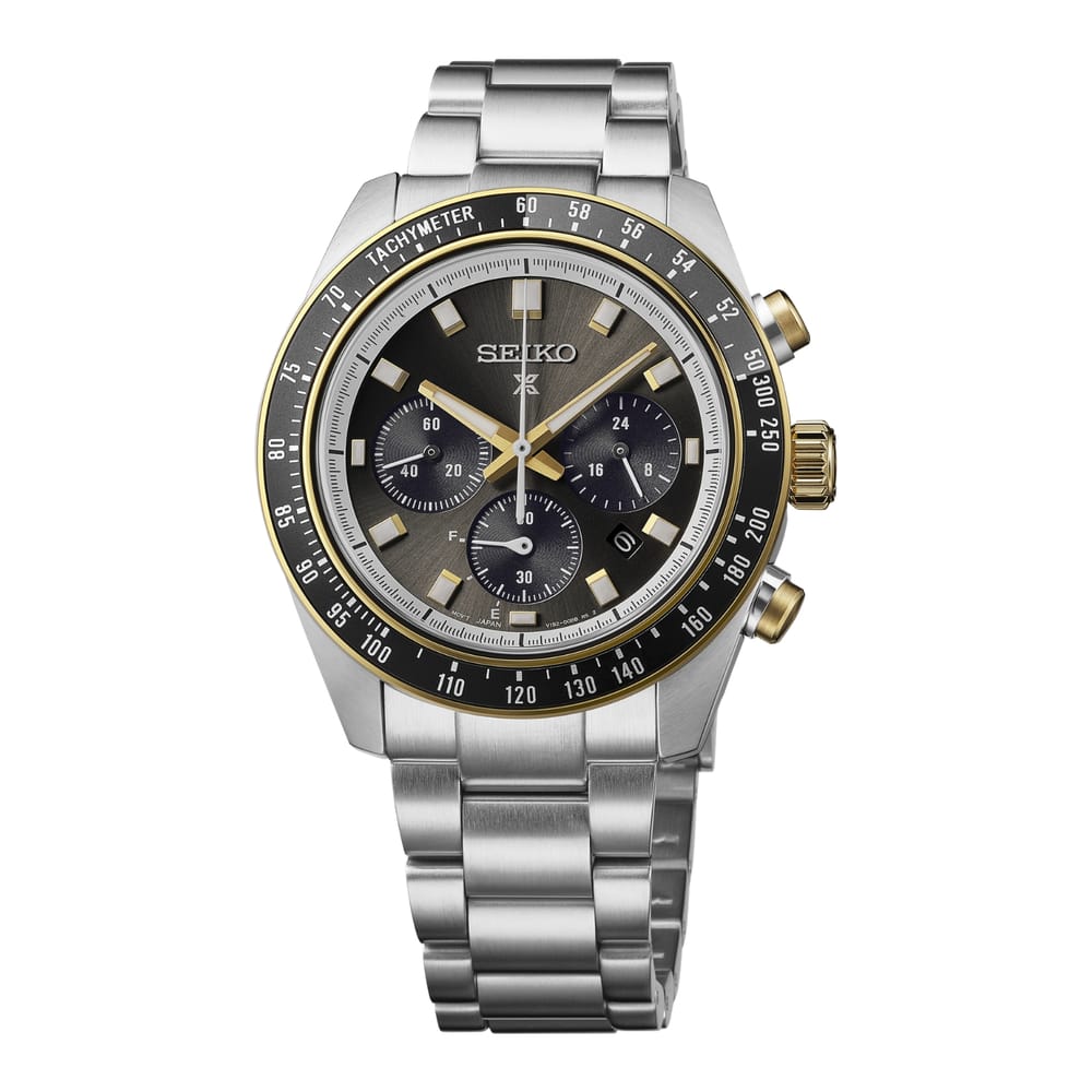 A Seiko stainless steel chronograph watch with a dark gray dial, gold-tone bezel markers, and a matching steel link bracelet, shown against a plain white background.