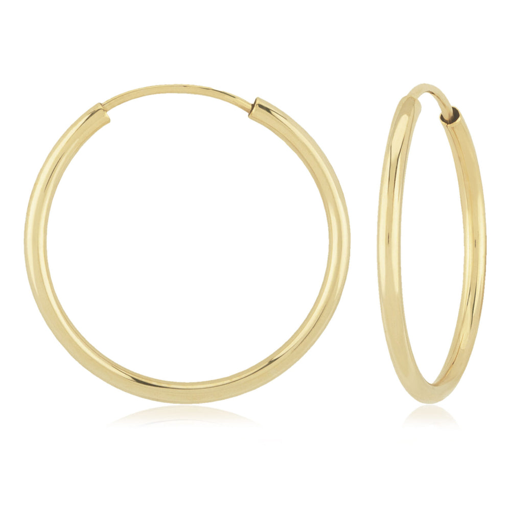 Gold hoop earrings on a white background