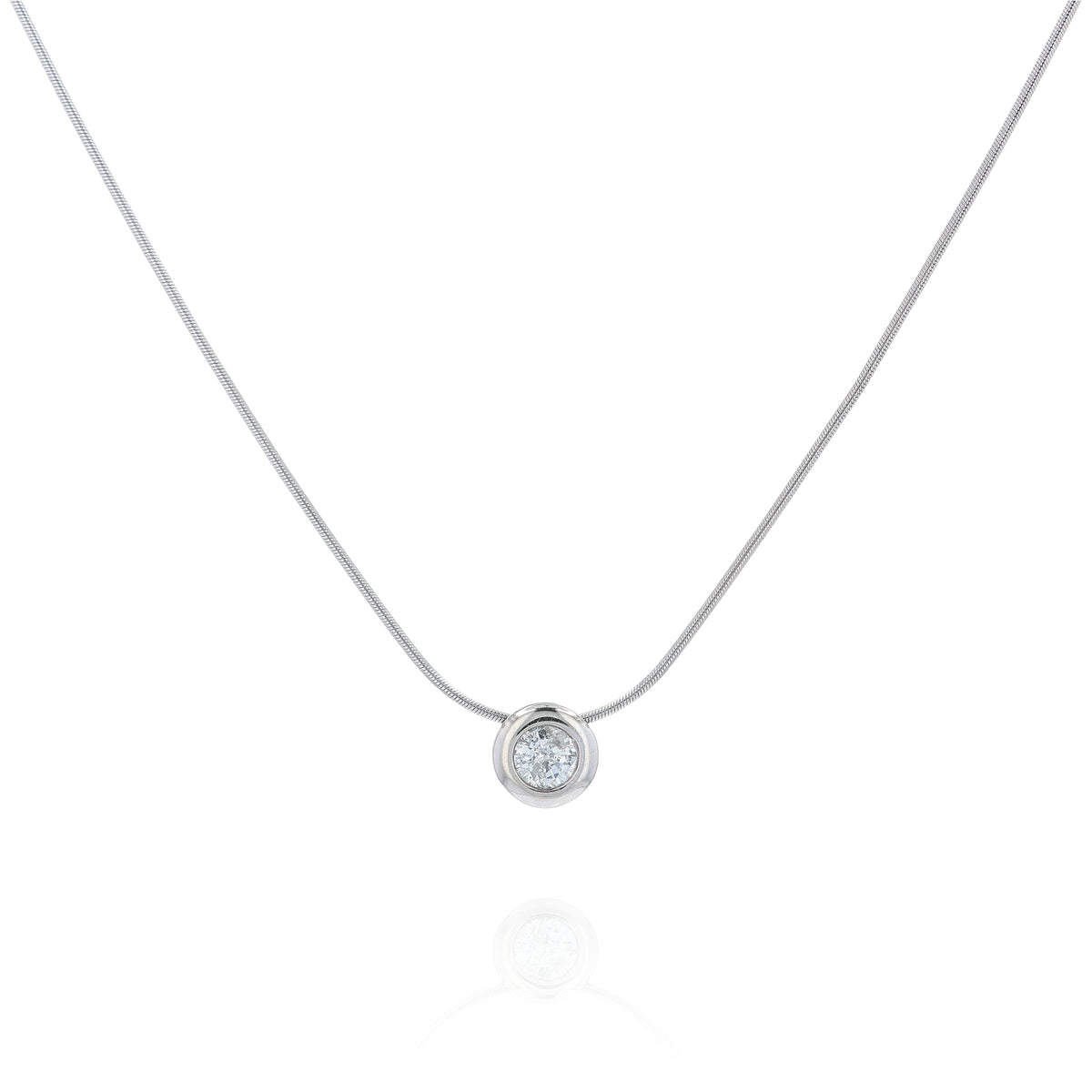 A delicate gold snake chain necklace with a single round bezel-set diamond pendant, displayed against a clean white background.