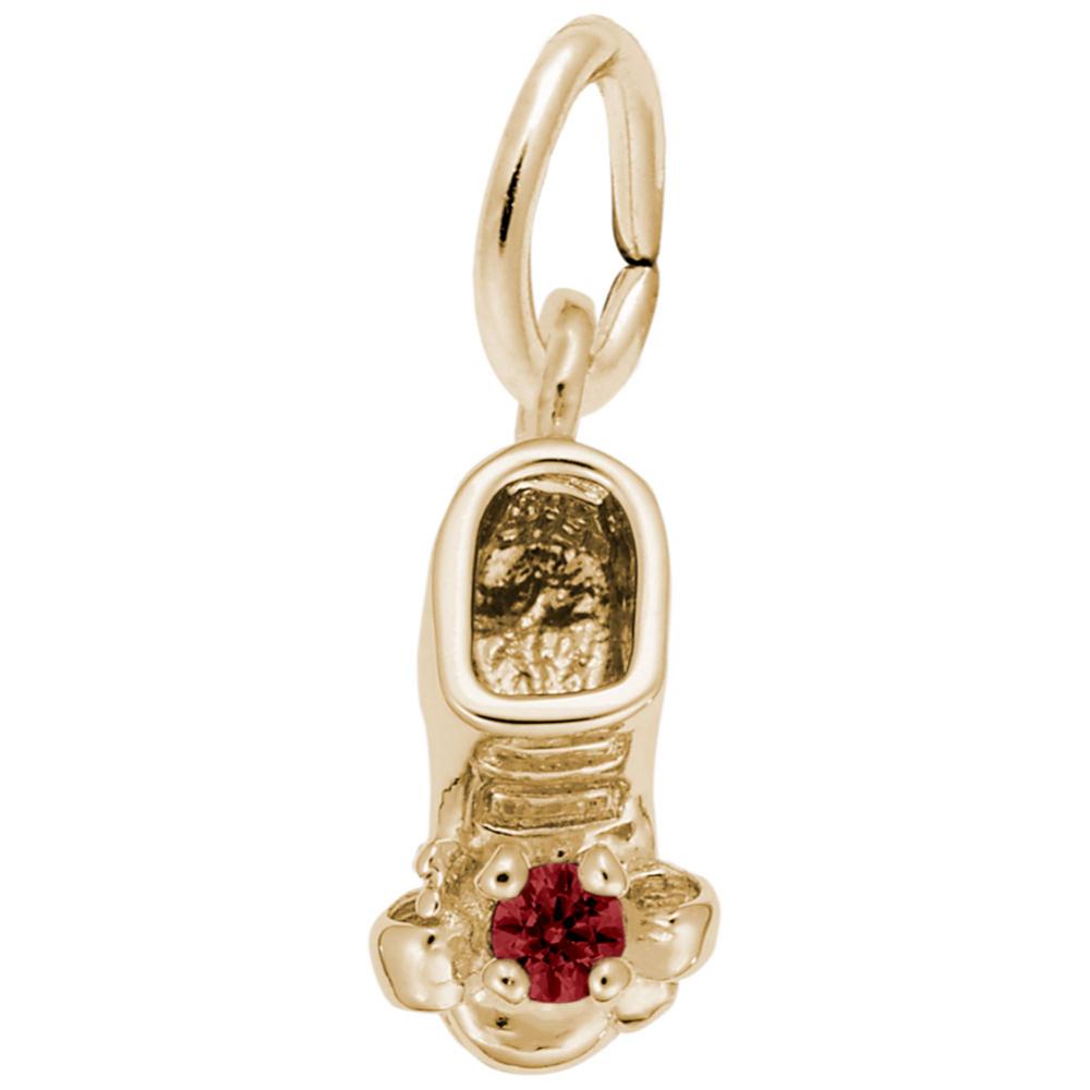 Gold baby-bootie charm with a red gemstone on a white background