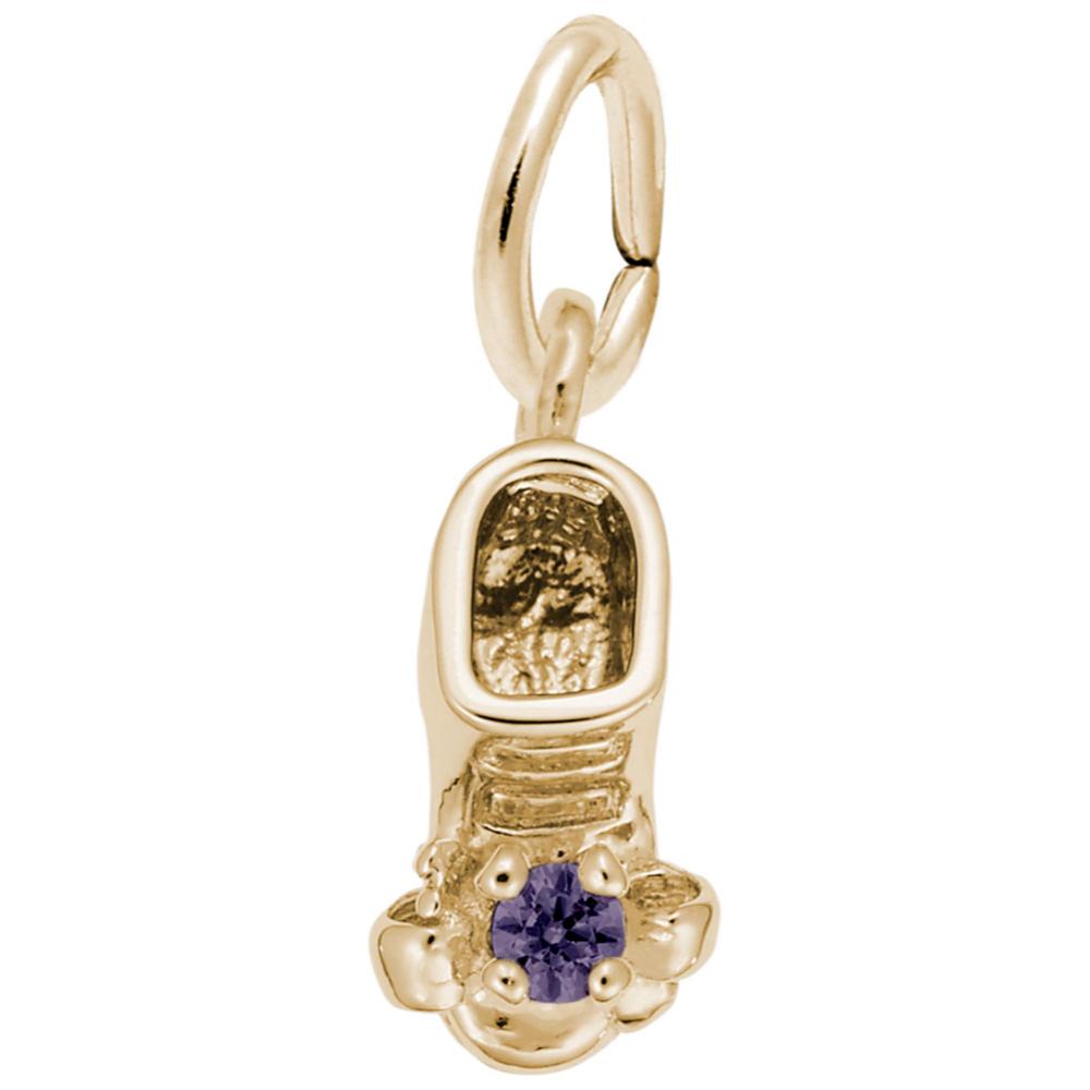 Gold baby-bootie charm with a purple gemstone on a white background