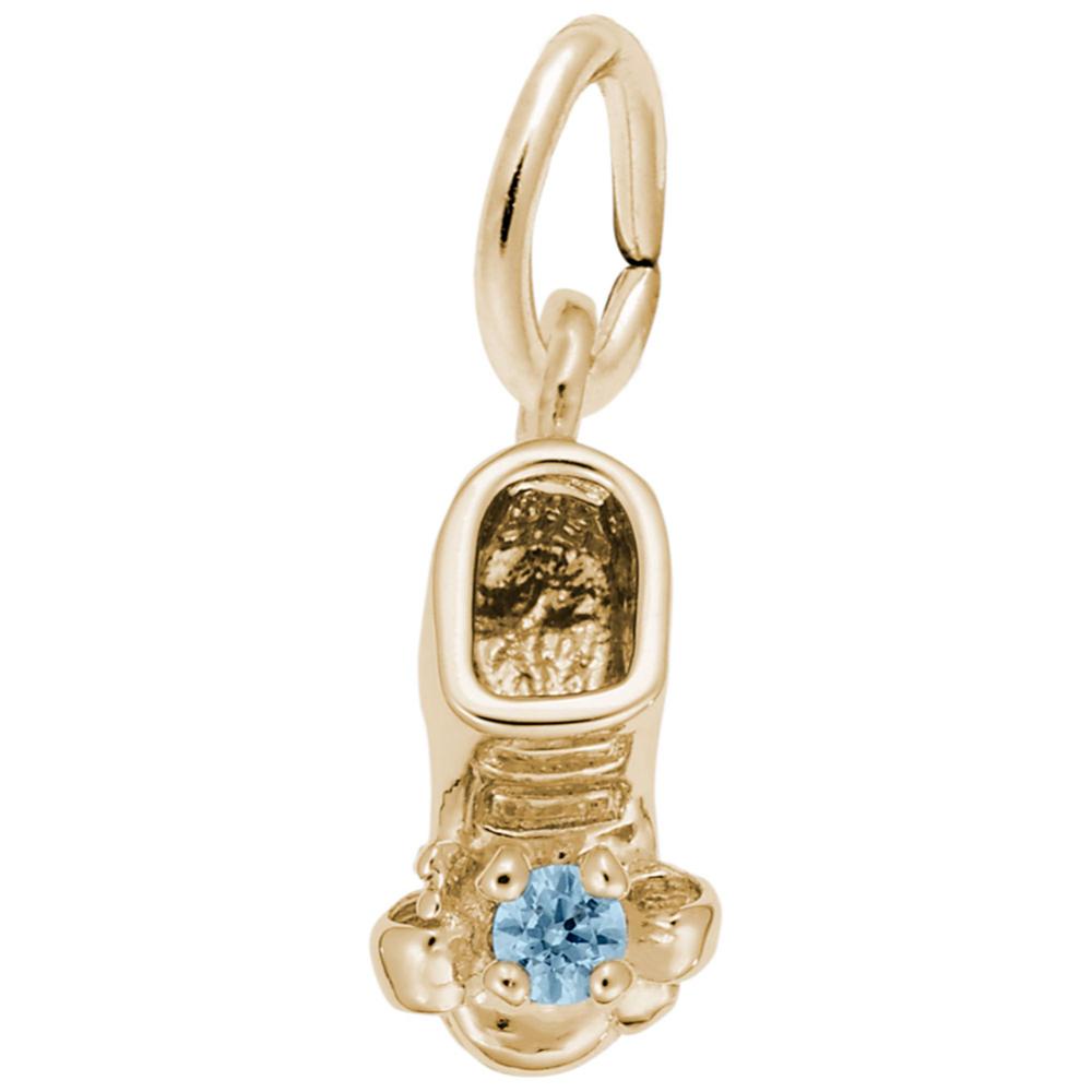 Gold baby-bootie charm with a blue gemstone on a white background