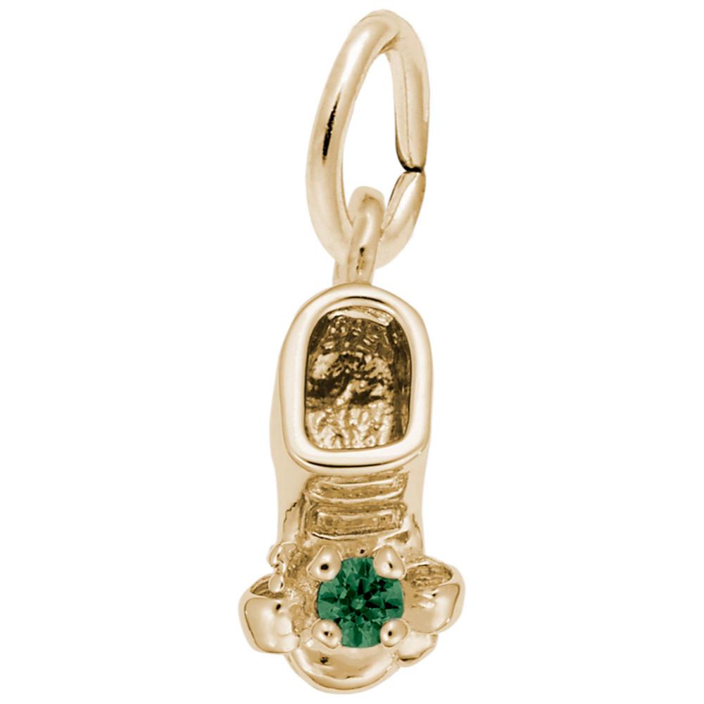 Gold baby-bootie charm with a green gemstone on a white background