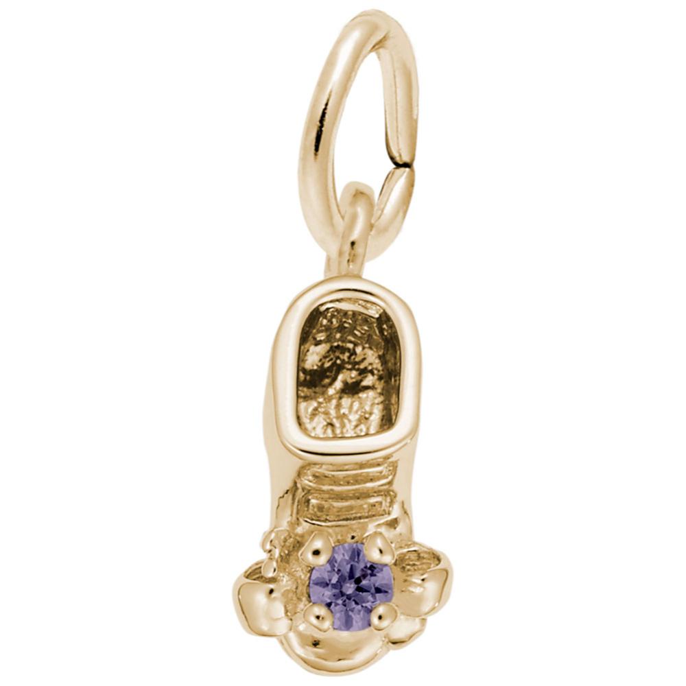 Gold baby-bootie charm with a purple gemstone on a white background