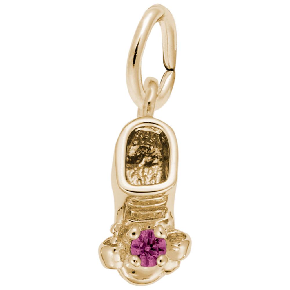 Gold baby-bootie charm with a purple gemstone on a white background