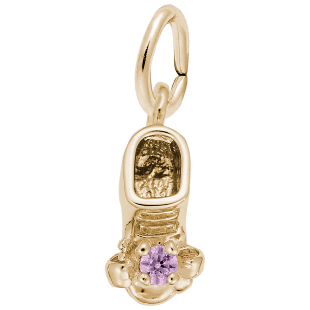 Gold baby-bootie charm with a purple gemstone on a white background