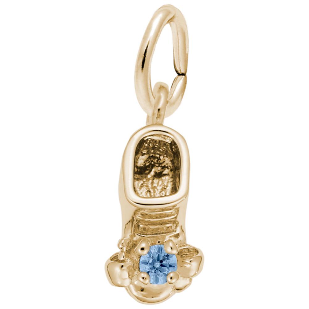 Gold baby-bootie charm with a blue gemstone on a white background