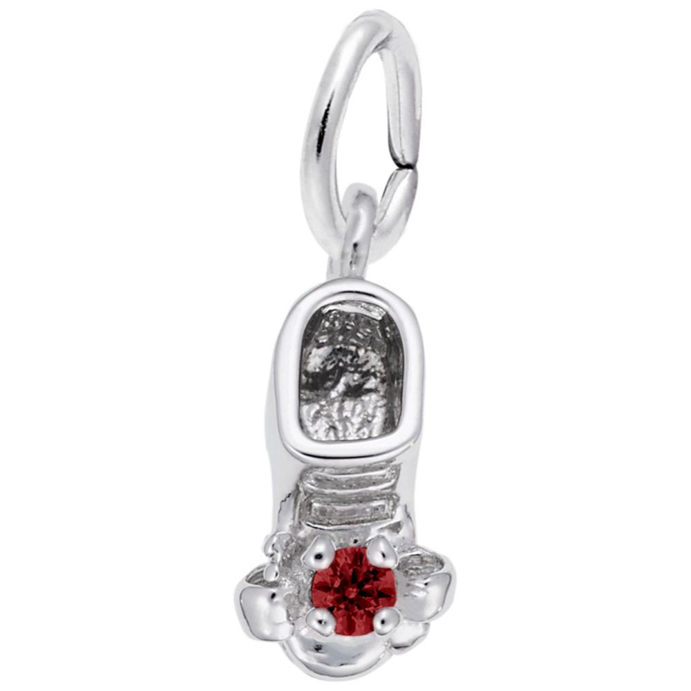 Silver baby-bootie charm with a red gemstone on a white background