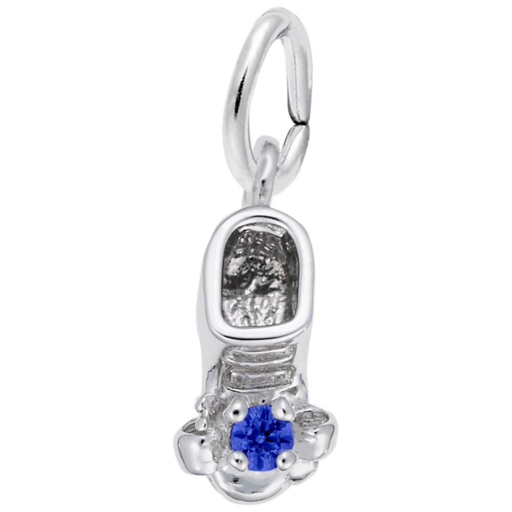 Silver baby-bootie charm with a blue gemstone on a white background