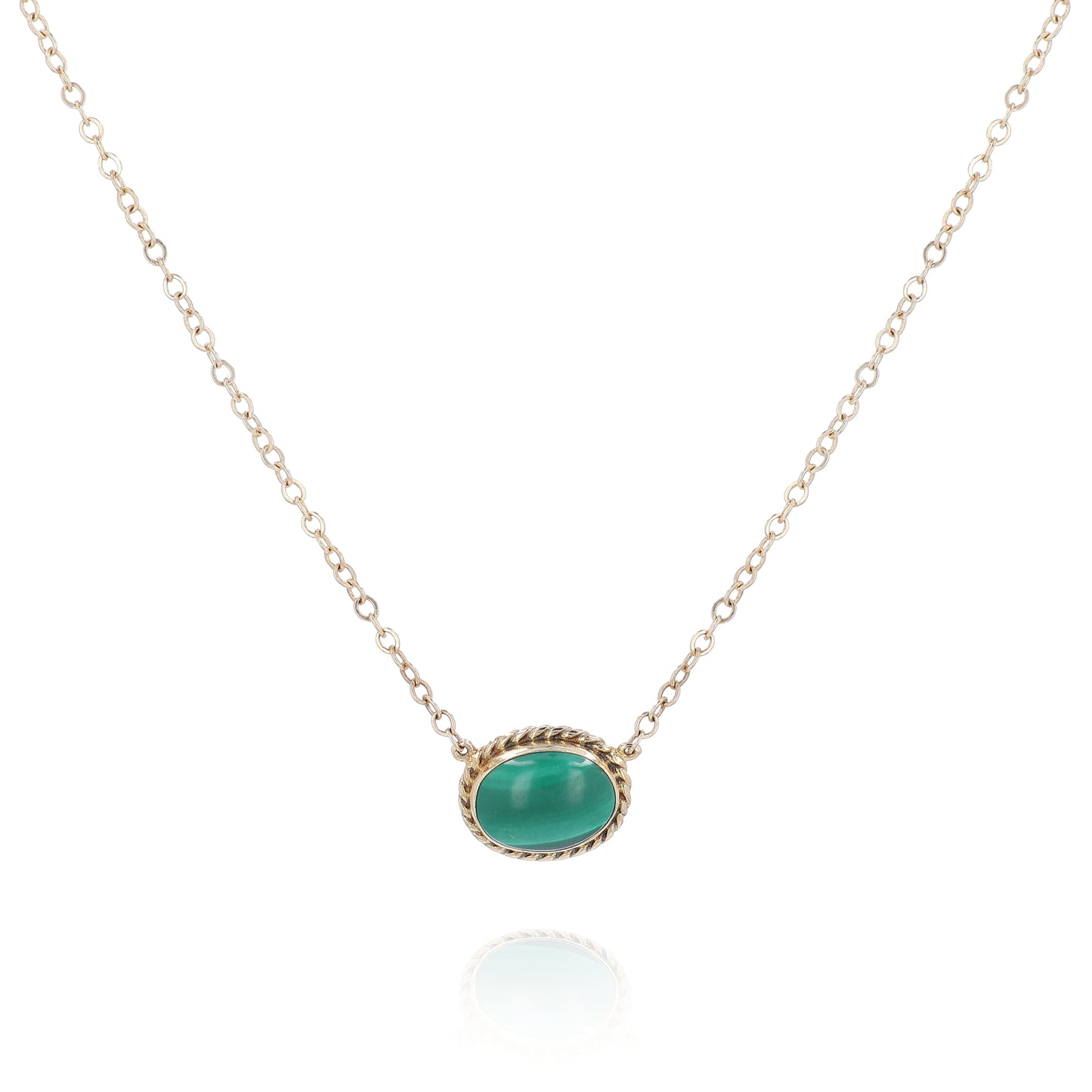 Yellow gold oval malachite pendant necklace on a white background