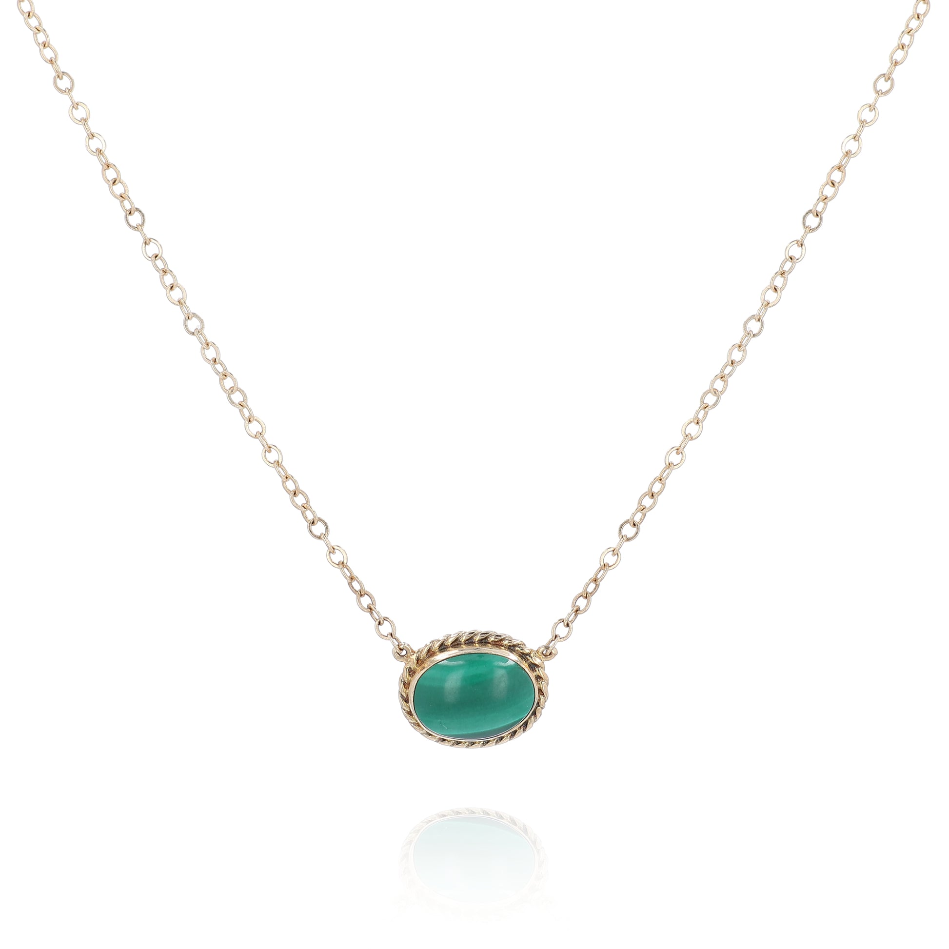 Yellow gold oval malachite pendant necklace on a white background