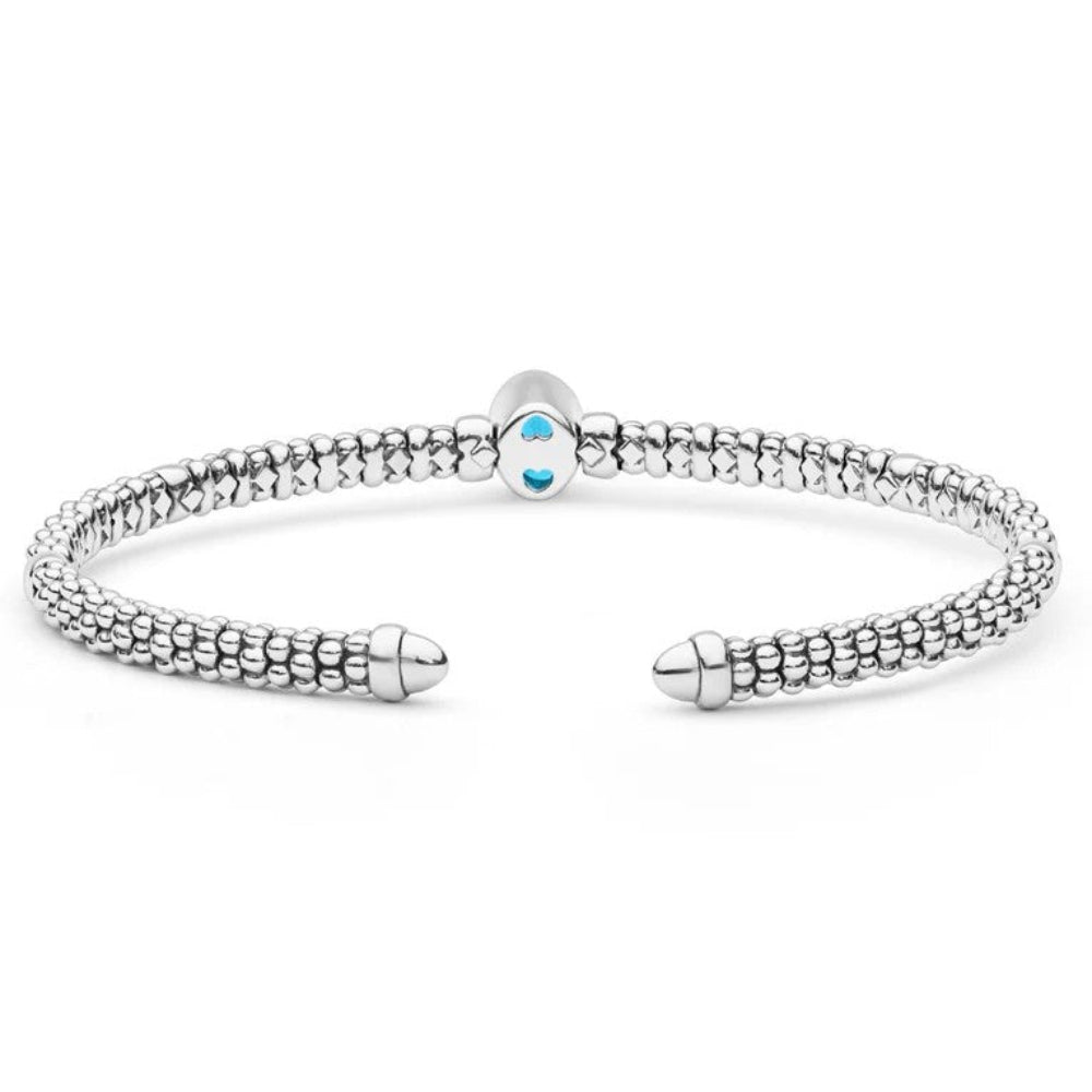 A textured beaded sterling silver open cuff bracelet with a  central blue topaz
