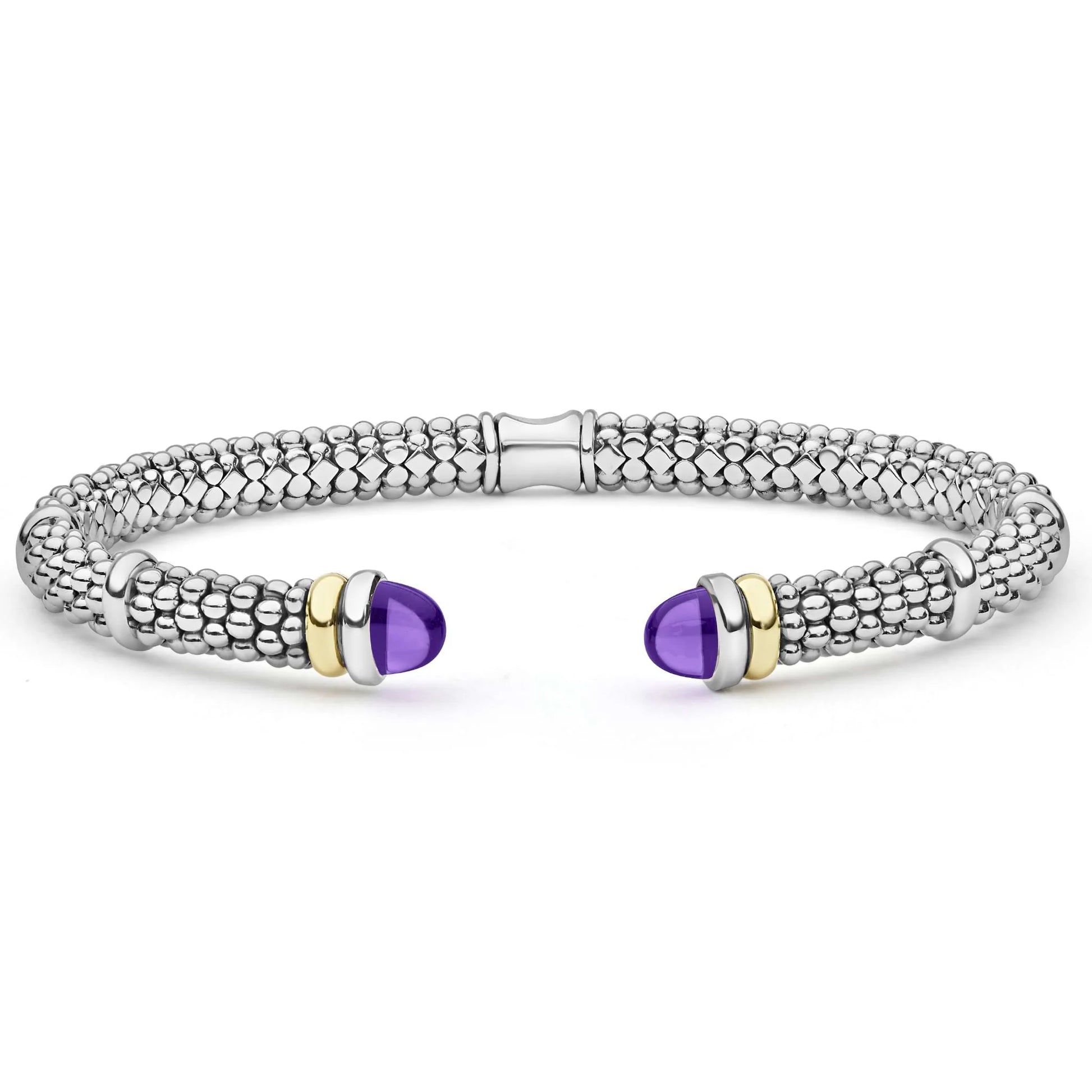 A silver-toned textured cuff bracelet with two purple cabochon gemstone accents, each bordered by gold and silver metal bands, shown on a white background.
