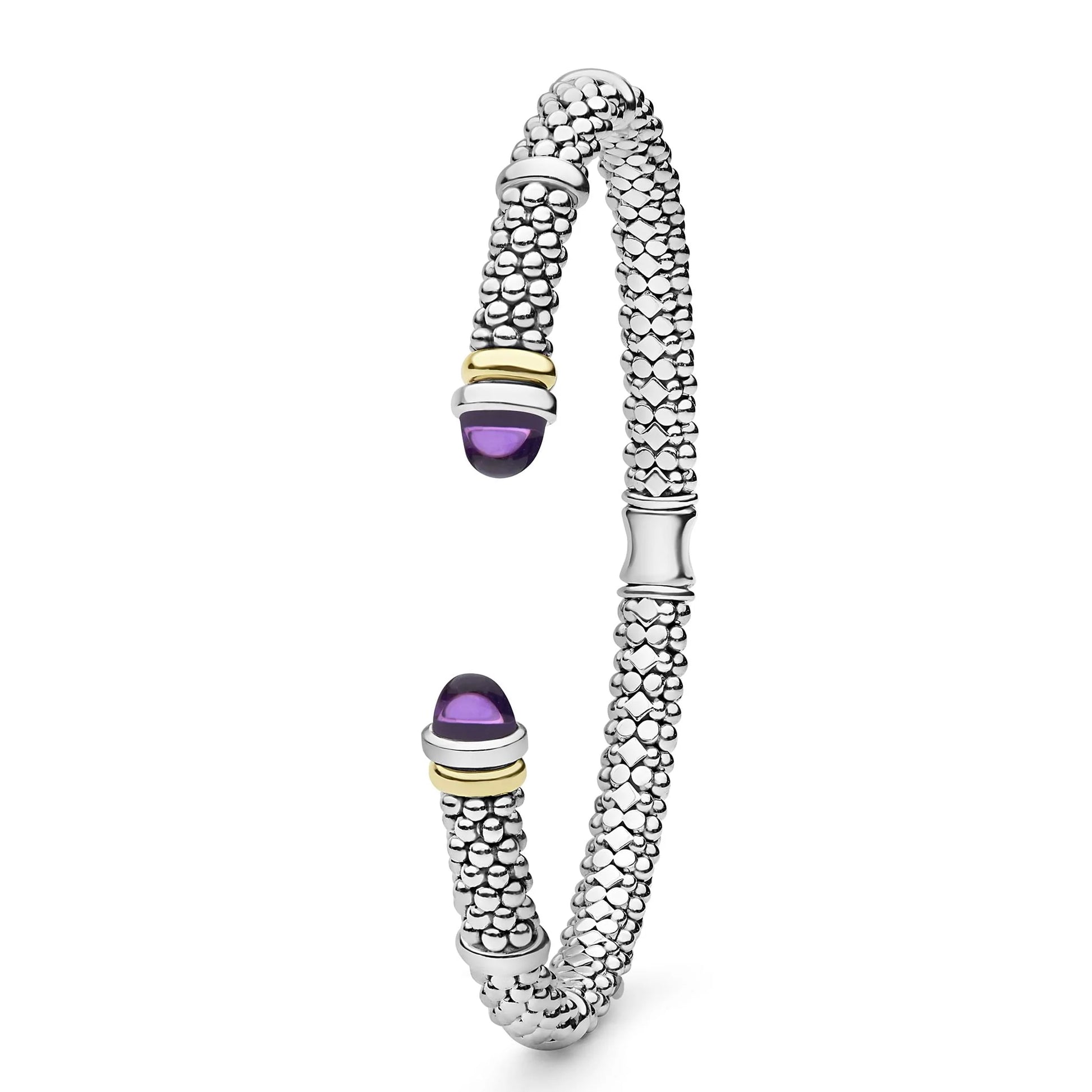 A silver-toned textured bangle bracelet with two purple amethyst cabochon stones and small gold-toned accent rings, shown on a clean white background.