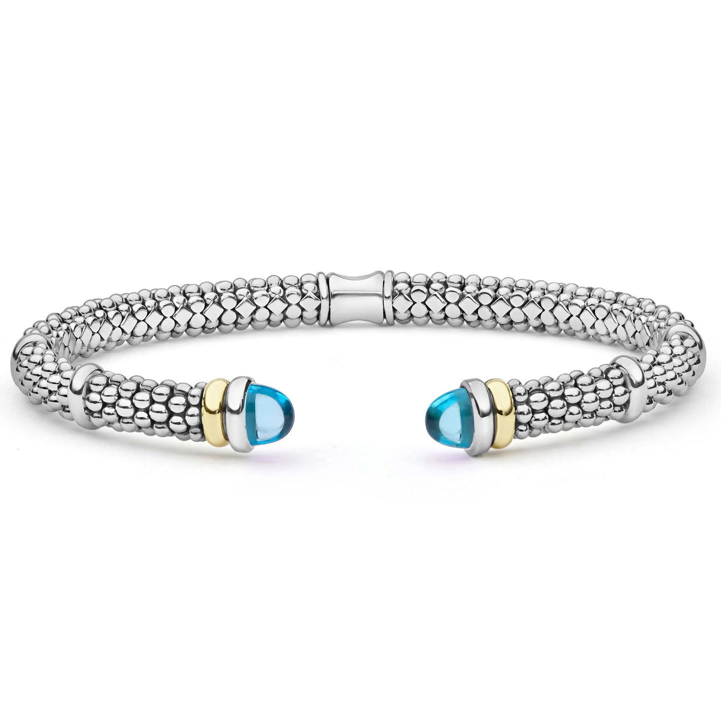 A silver-toned textured cuff bracelet with two gold-toned end accents and light blue oval gemstones, shown on a plain white background.