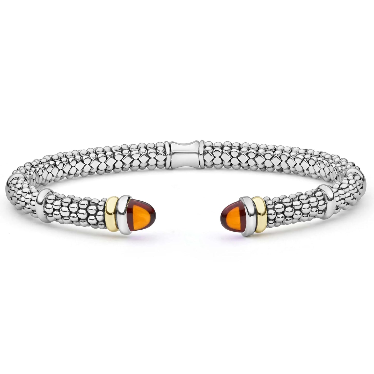 A silver-toned textured cuff bracelet with polished gold-toned end spacers and oval amber-colored stone accents, shown on a plain white background.