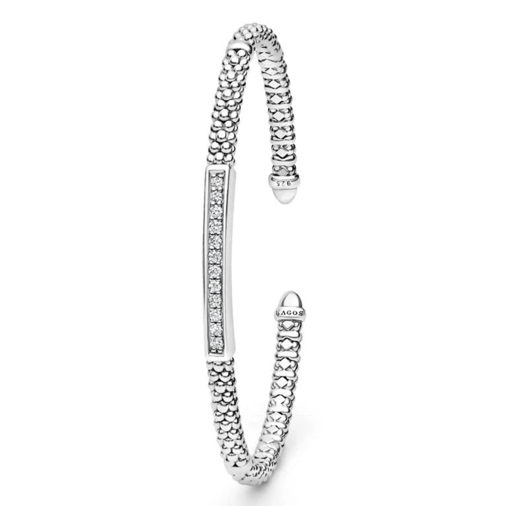 A sterling silver cuff bangle bracelet featuring a textured beaded  design, a polished central bar set with a centered diamond station 