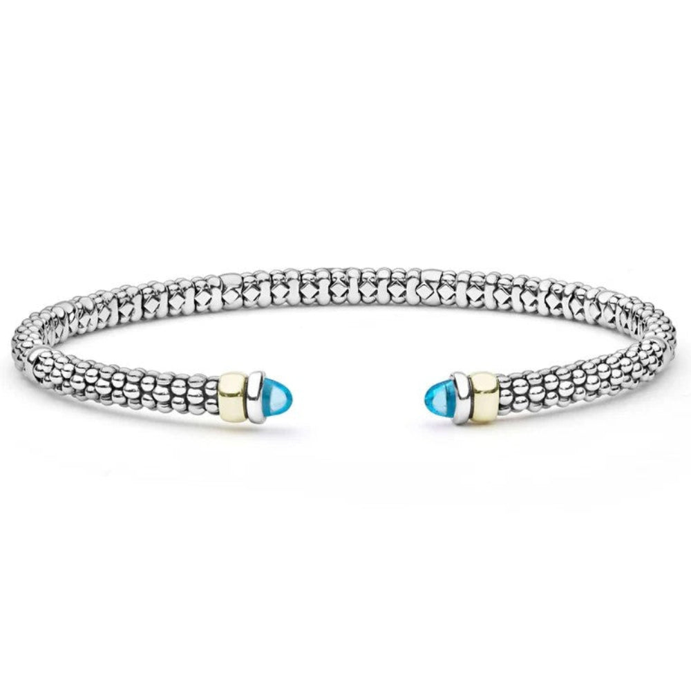 A Sterling silver textured beaded cuff bracelet with two gold-toned end caps, each featuring a blue topaz end cabochons 