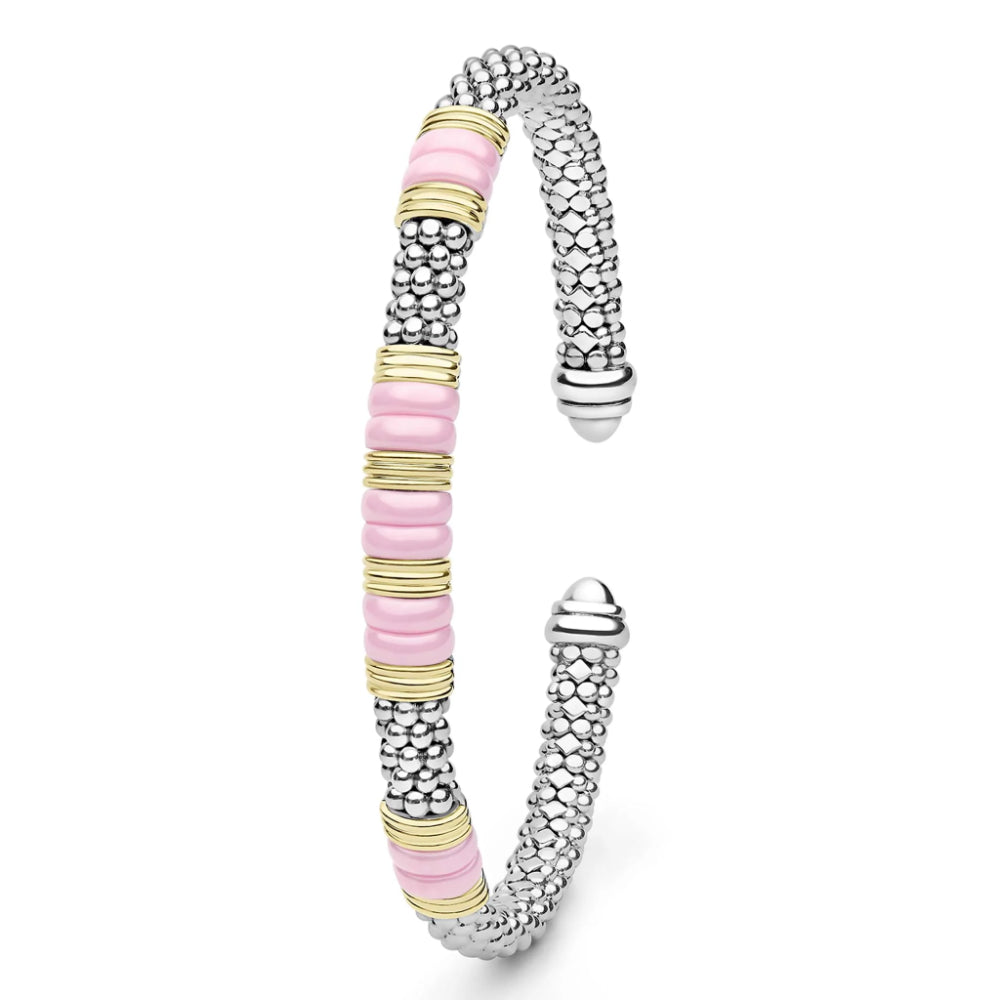 A silver-toned textured cuff bracelet with alternating rows of light pink and gold-toned round beads, shown on a clean white background.