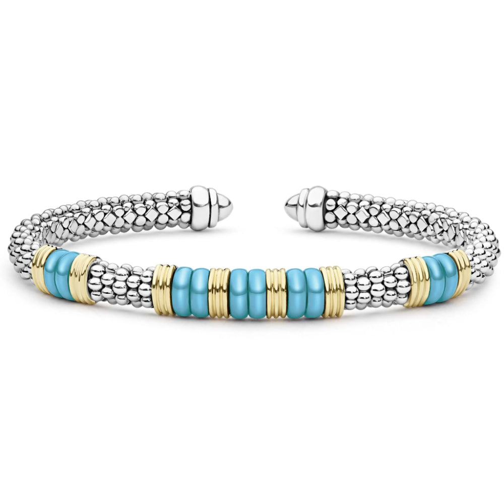 A silver-toned beaded cuff bracelet with a central row of turquoise blue beads accented by gold-toned spacer rings, shown on a plain white background.
