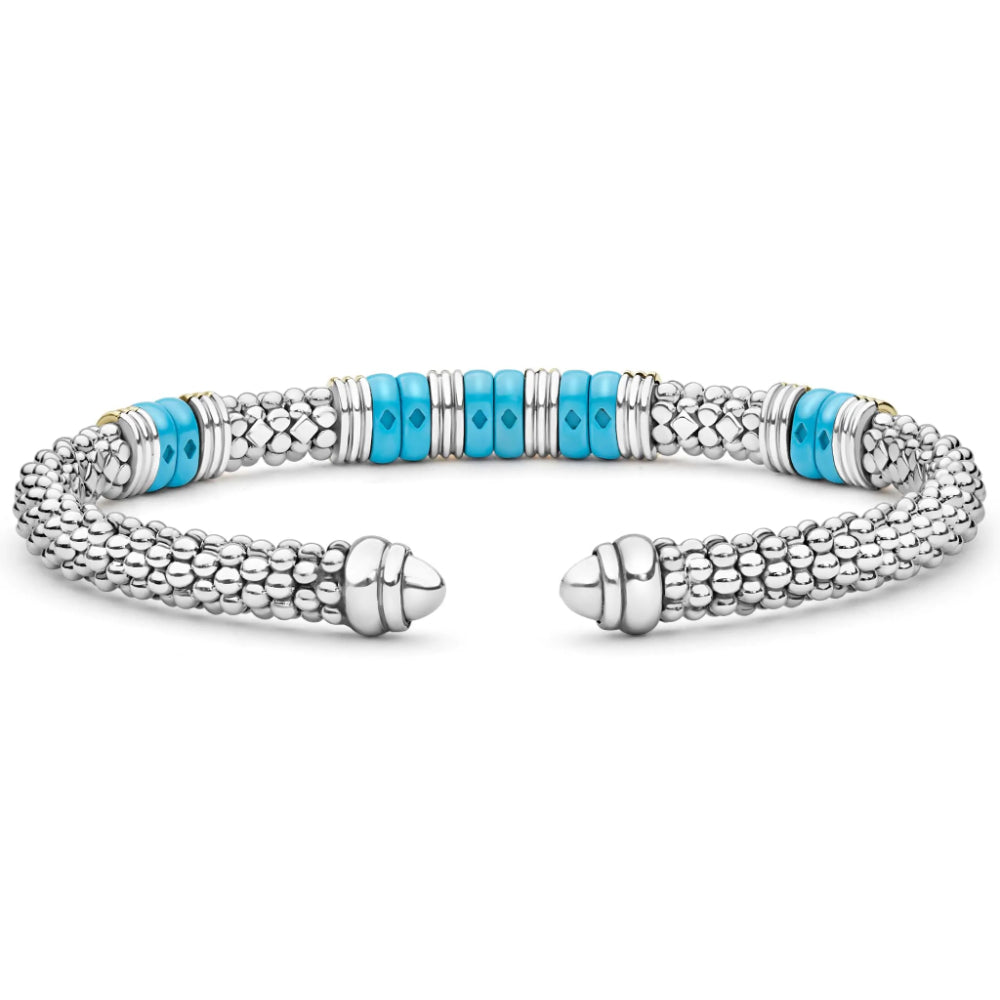 A silver-toned textured cuff bracelet with a central row of bright turquoise blue beads, shown on a plain white background.
