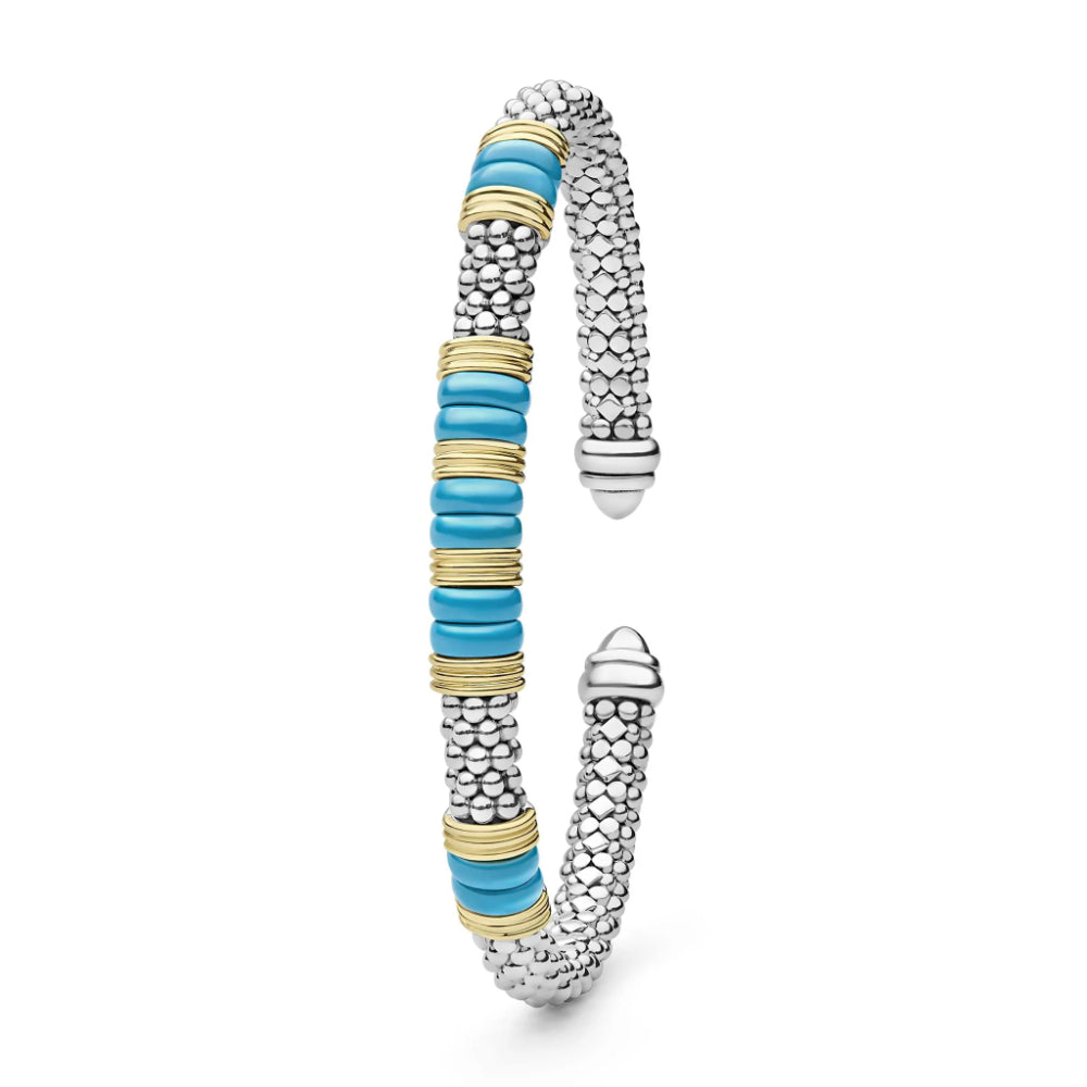 A silver-toned textured cuff bracelet with a central column of turquoise blue discs separated by thin gold bands, shown on a clean white background.