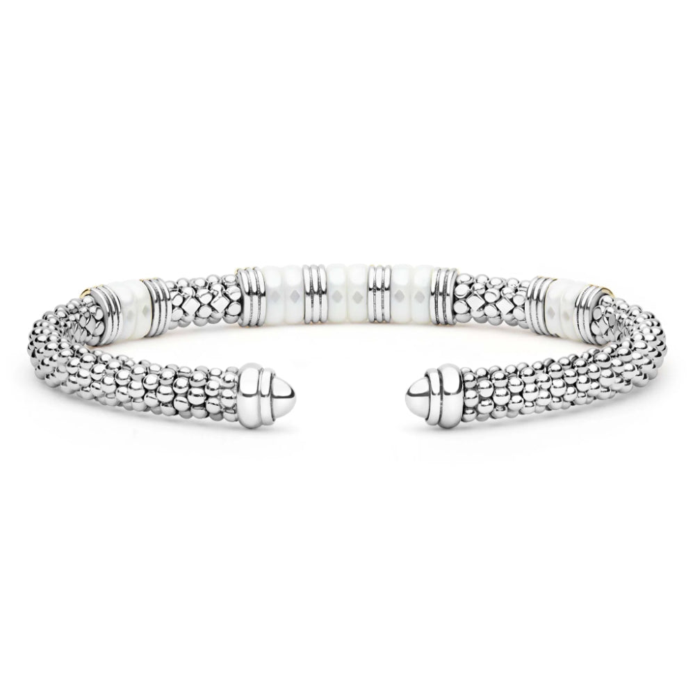 A silver-toned textured cuff bracelet with white pearl-like bead accents, displayed on a clean white background.