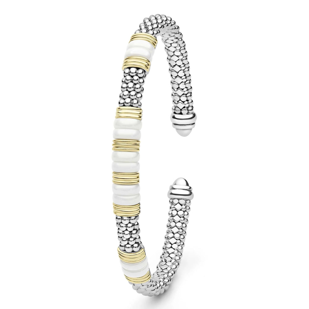 A two-tone cuff bracelet featuring textured silver-tone metal, polished white beads, and gold-tone spacer rings, displayed on a clean white background.