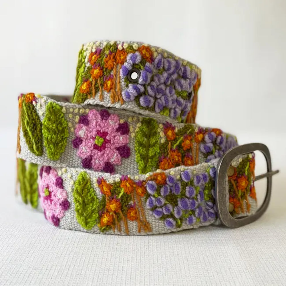 A colorful embroidered wool belt with a floral pattern and a metal buckle, displayed on a white background.