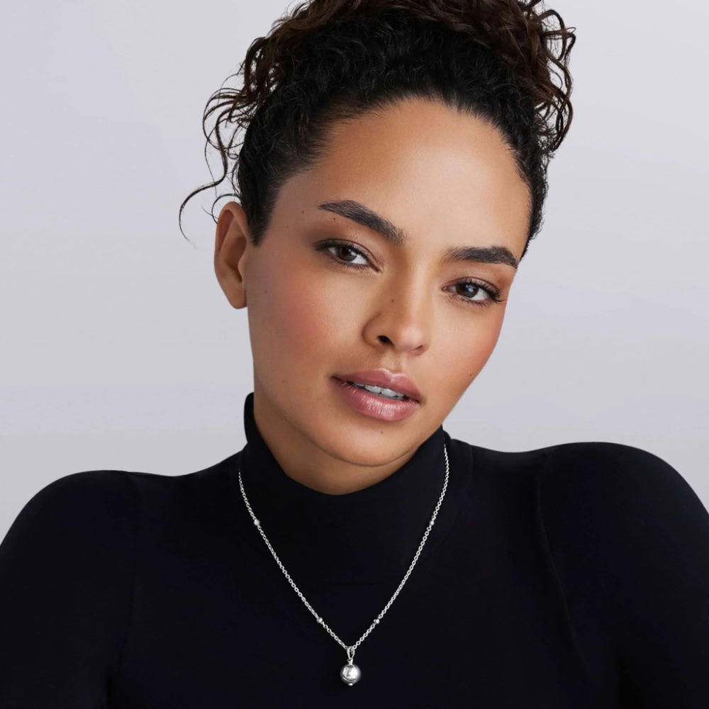 Woman wearing sterling silver necklace with bubble pendant