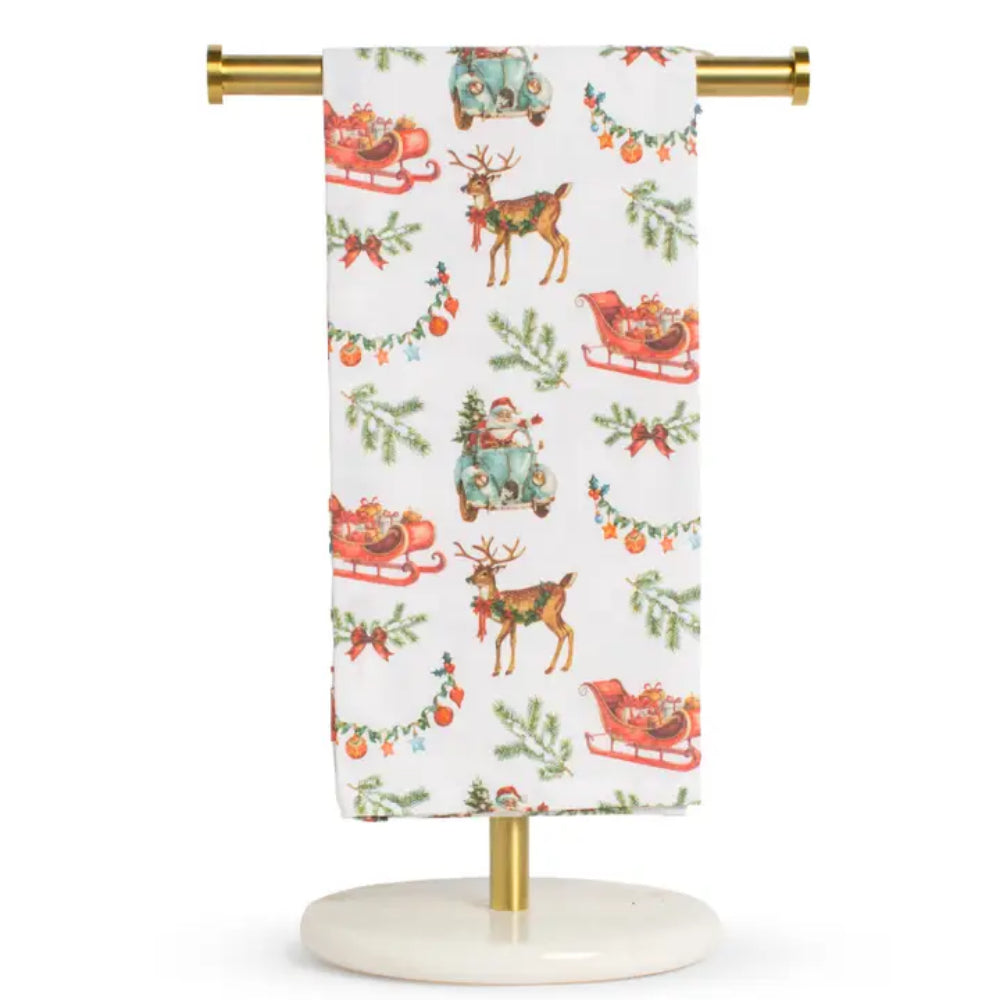 A Christmas hand kitchen dish towel with reindeer, sleighs, and santa clauses on a white background. 
