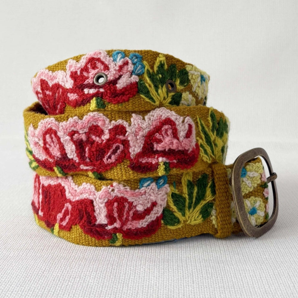 Floral patterned belt with a metal buckle on a white background