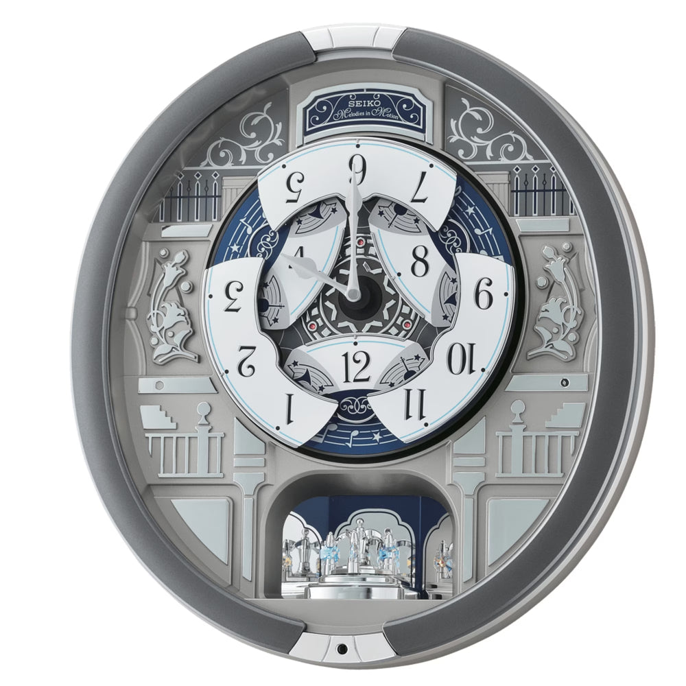 A circular, highly detailed mechanical wall clock with a silver and gray outer frame, a white central dial with black numerals, and blue accents, set against a plain white background.