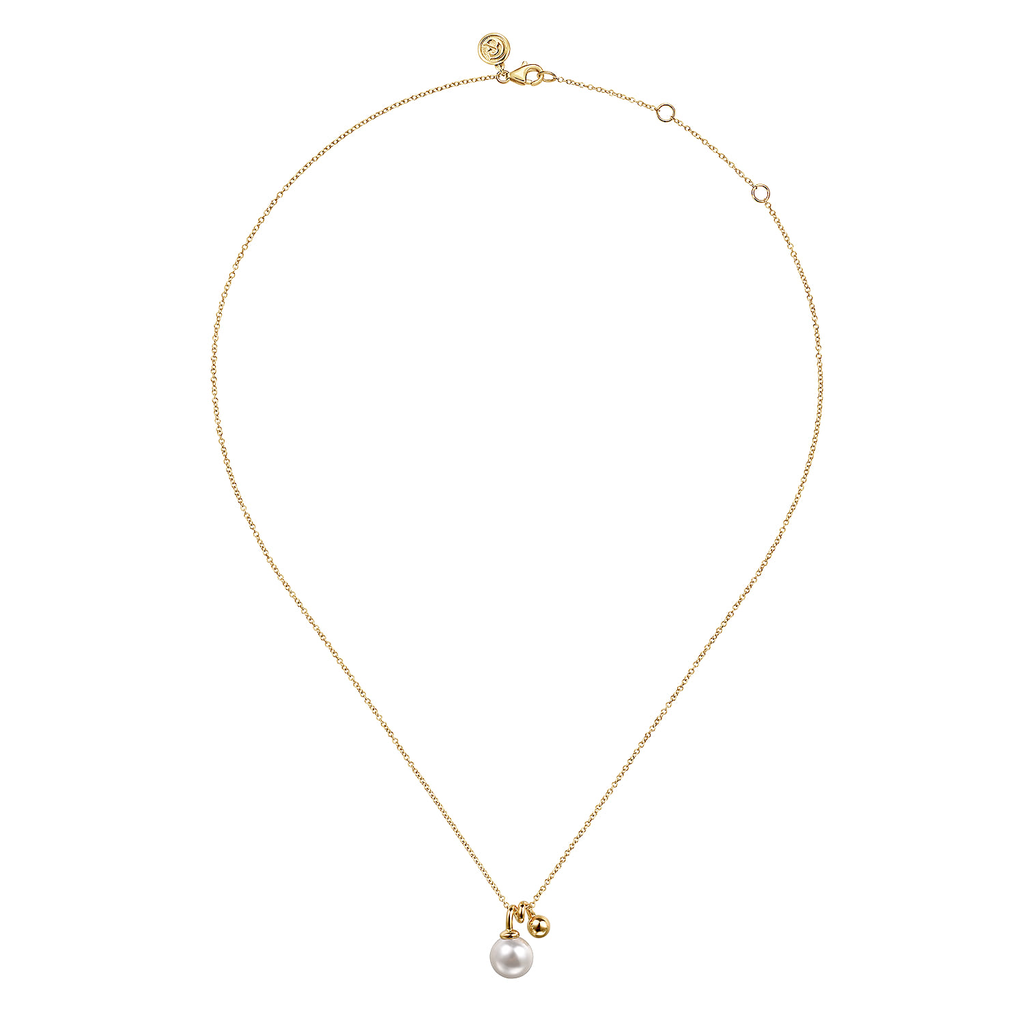 Pearl pendant on yellow gold chain on white background