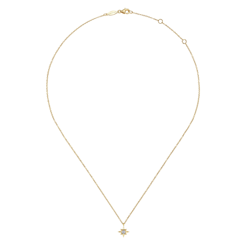 Gold necklace with a star pendant on a white background