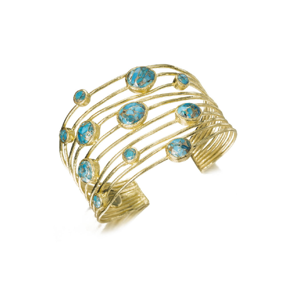 A gold-toned open cuff bracelet featuring multiple curved rows of small round and oval turquoise-blue gemstones, shown on a plain white background.