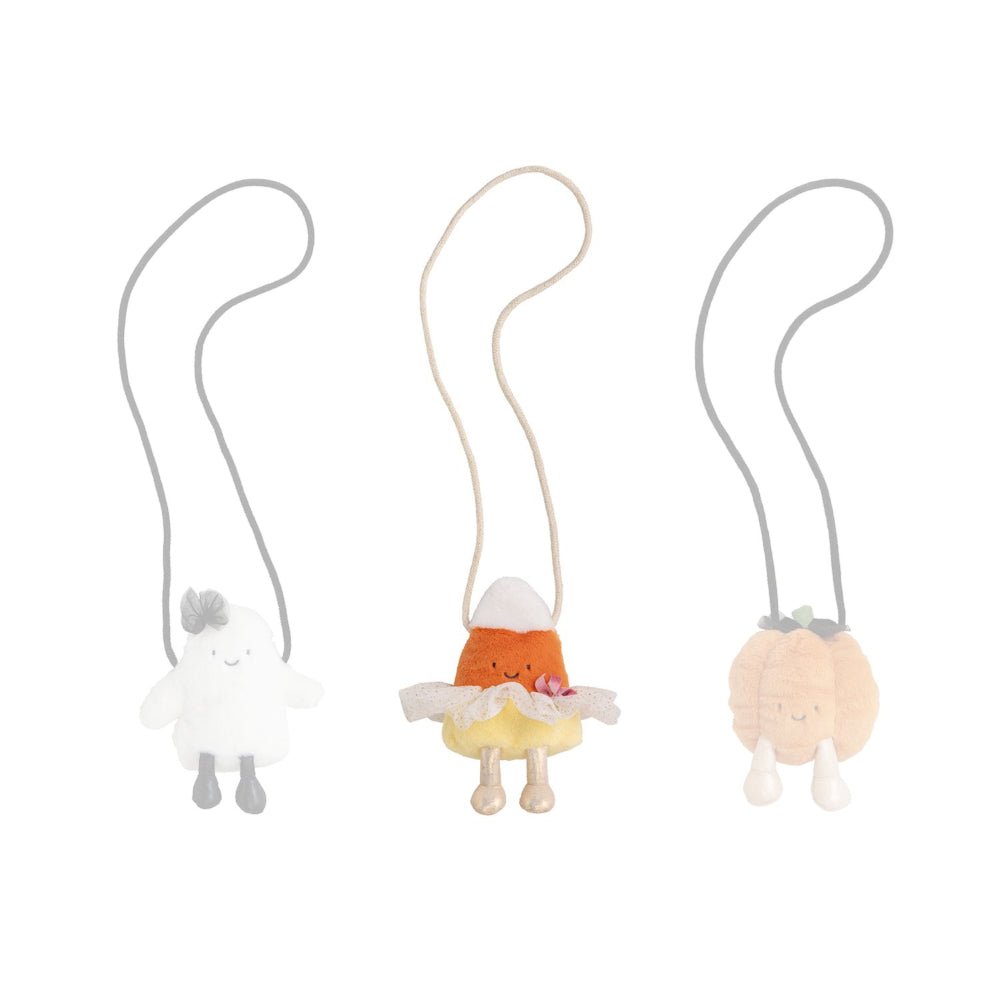 Candy Corn themed halloween plush purse against a white background.