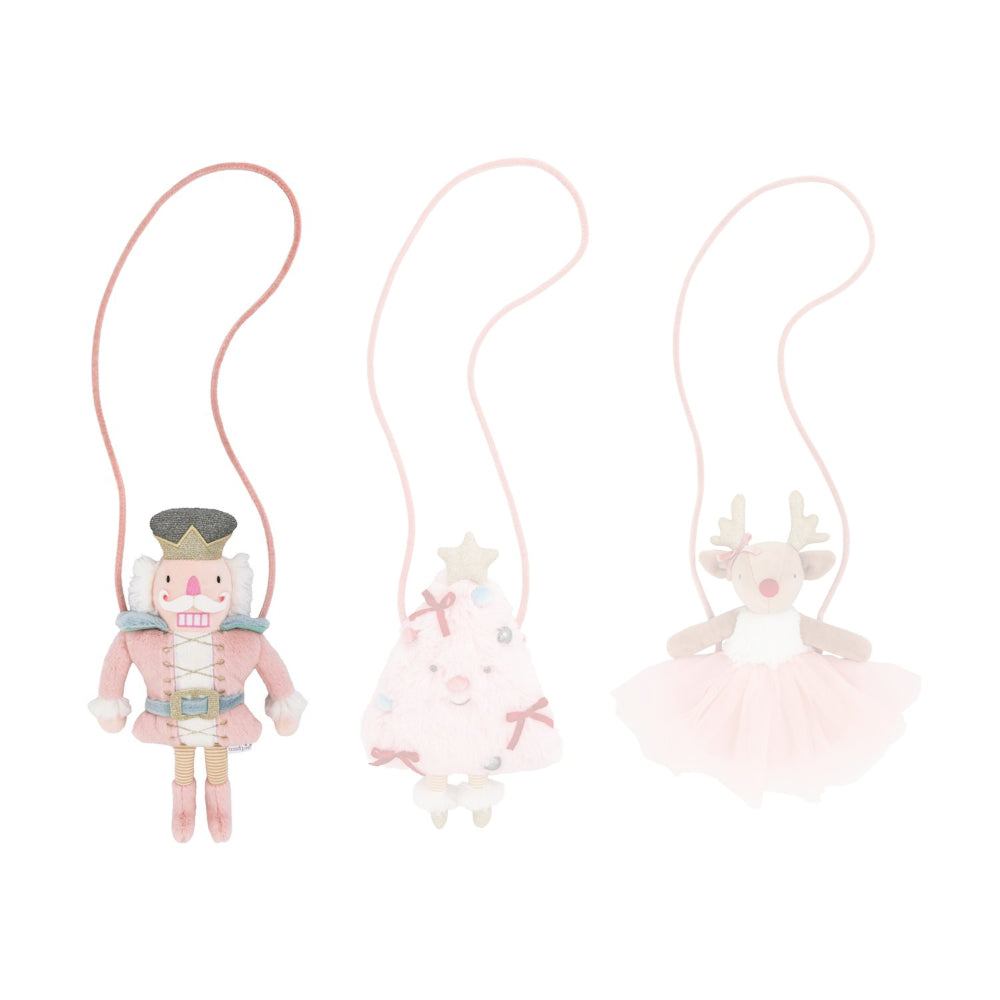 Pink nutcracker plush bag against a white background.