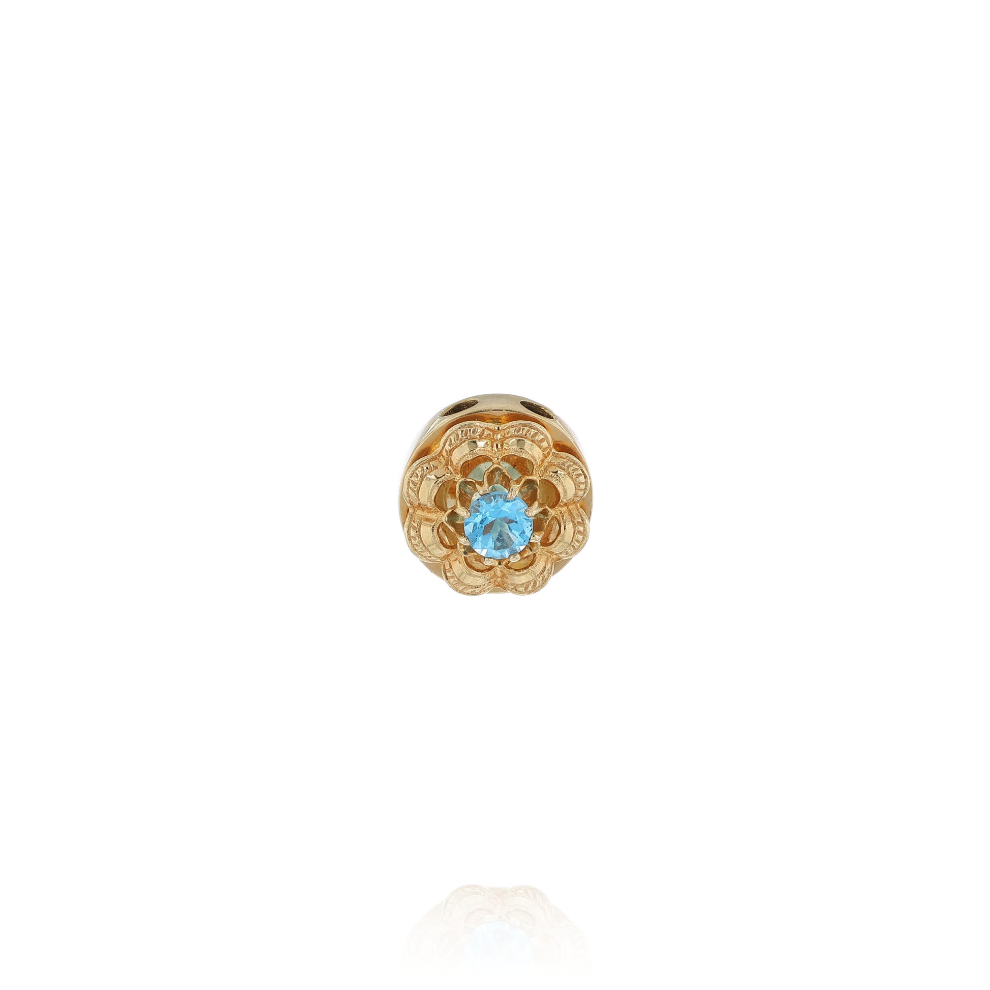 Yellow gold Victorian slide pendant with a blue topaz center and scalloped border on a white background